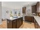 Bright kitchen features an island with cooktop, stainless steel appliances, and hardwood floors at 3510 Middlebrook Dr, Durham, NC 27705