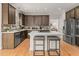 Modern kitchen featuring a large island, hardwood floors, and stainless steel appliances at 3510 Middlebrook Dr, Durham, NC 27705