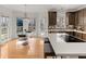 Sunlit breakfast nook with a glass table beside a stylish kitchen with island at 3510 Middlebrook Dr, Durham, NC 27705