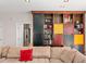 Spacious living room with a large built-in bookcase featuring colorful doors and shelving at 3510 Middlebrook Dr, Durham, NC 27705