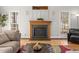 Cozy living room featuring a fireplace with wood mantle and hardwood floors at 3510 Middlebrook Dr, Durham, NC 27705