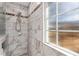 Walk-in shower with tiled walls, a showerhead, and a frosted glass window at 3510 Middlebrook Dr, Durham, NC 27705