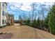 Spacious backyard featuring a stone patio, fireplace, and landscaped garden, perfect for outdoor entertaining and relaxation at 5025 Fanyon Way, Raleigh, NC 27612