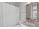 Bathroom featuring a vanity with solid countertop, an ornate mirror, and a shower-tub combo at 5025 Fanyon Way, Raleigh, NC 27612