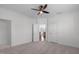 Bright bedroom with neutral walls, carpet, ceiling fan and a view to the home's second floor at 5025 Fanyon Way, Raleigh, NC 27612