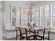 Charming dining area features shuttered windows, a built-in bench, and a stylish chandelier at 5025 Fanyon Way, Raleigh, NC 27612