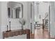 Inviting entryway boasts hardwood floors, elegant trim, and a stylish console table with decorative mirror at 5025 Fanyon Way, Raleigh, NC 27612