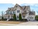 Elegant two-story house boasts black shutters, attached garage, and carefully manicured landscaping at 5025 Fanyon Way, Raleigh, NC 27612