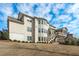 Expansive backyard view of this multi-story home with a screened-in porch and lush landscaping at 5025 Fanyon Way, Raleigh, NC 27612