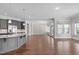 Bright living room with hardwood floors, wet bar, and views of the surrounding landscape at 5025 Fanyon Way, Raleigh, NC 27612
