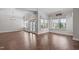 Bright living room with hardwood floors, chandelier and views of the surrounding landscape at 5025 Fanyon Way, Raleigh, NC 27612