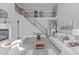Open living space with a fireplace, a staircase with iron railings, and neutral color palette at 5025 Fanyon Way, Raleigh, NC 27612