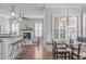 View of open-concept living space with wood floors, fireplace, breakfast bar, and dining area at 5025 Fanyon Way, Raleigh, NC 27612