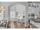 Open-concept living room with high ceilings, built-in shelving, a fireplace, and seamless flow at 5025 Fanyon Way, Raleigh, NC 27612