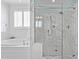 Clean and bright bathroom featuring a soaking tub and luxurious marble shower at 5025 Fanyon Way, Raleigh, NC 27612