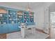 Chic home office showcases blue built-in shelves, modern decor, and stylish pendant lighting at 5025 Fanyon Way, Raleigh, NC 27612