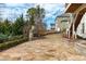 Backyard with stone patio, outdoor fireplace, and landscaped garden, perfect for relaxing at 5025 Fanyon Way, Raleigh, NC 27612