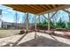 Covered outdoor patio with flagstone paving, wooden ceiling, and backyard view at 5025 Fanyon Way, Raleigh, NC 27612