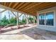 Covered outdoor patio with flagstone paving, wooden ceiling, stone fireplace, and backyard view at 5025 Fanyon Way, Raleigh, NC 27612