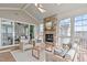 A screened-in porch features a stone fireplace, comfortable seating, skylights, and exterior views at 5025 Fanyon Way, Raleigh, NC 27612