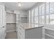 A large walk-in closet with custom shelving and a center island provides ample storage space at 5025 Fanyon Way, Raleigh, NC 27612