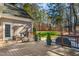 Back deck with swing, bench, grill, and fenced yard surrounded by lush trees at 5300 Grand Gate Dr, Raleigh, NC 27613