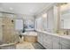 Bright bathroom features a soaking tub, a large glass shower, and double sink vanity at 5300 Grand Gate Dr, Raleigh, NC 27613