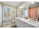Bright bathroom features a double sink vanity, a large window, and neutral decor at 5300 Grand Gate Dr, Raleigh, NC 27613