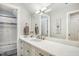 Bright bathroom featuring a spacious vanity, white cabinets, and shower with white tiled walls at 5300 Grand Gate Dr, Raleigh, NC 27613