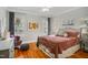 Comfortable bedroom with hardwood floors, neutral walls, and natural light from two windows at 5300 Grand Gate Dr, Raleigh, NC 27613