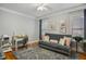 Flex bedroom with a futon, desk, hardwood floors, and neutral walls providing lots of natural light at 5300 Grand Gate Dr, Raleigh, NC 27613