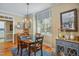 Cozy dining room with crown molding, hardwood floors, stylish lighting, and a large window at 5300 Grand Gate Dr, Raleigh, NC 27613