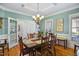 Elegant dining room with chandelier, wainscoting and views of backyard at 5300 Grand Gate Dr, Raleigh, NC 27613