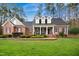 Charming brick home with well-manicured lawn, mature trees, and welcoming front porch at 5300 Grand Gate Dr, Raleigh, NC 27613