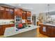 Gourmet kitchen features custom cabinets, granite counters, stainless appliances, and a center island cooktop at 5300 Grand Gate Dr, Raleigh, NC 27613