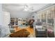 Well-lit living room featuring wood floors, a ceiling fan and cozy seating arrangements at 5300 Grand Gate Dr, Raleigh, NC 27613
