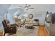 Inviting living room with hardwood floors, ceiling fan, comfortable seating and entertainment center at 5300 Grand Gate Dr, Raleigh, NC 27613