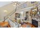 Bright living room featuring stone fireplace, staircase and hardwood floors at 5300 Grand Gate Dr, Raleigh, NC 27613