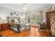 Relaxing primary bedroom features a large bed, hardwood floors, sitting area and natural light at 5300 Grand Gate Dr, Raleigh, NC 27613