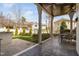 Covered outdoor space with dining table overlooks the lush lawn at 543 Guilford Cir, Raleigh, NC 27608