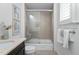 A bright bathroom features a shower over tub with decorative tile surround at 543 Guilford Cir, Raleigh, NC 27608