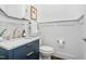 Bathroom with blue vanity, marble countertop, and gold fixtures at 543 Guilford Cir, Raleigh, NC 27608