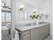 Bathroom with double vanity, marble countertop, decorative lighting, and a large mirror at 543 Guilford Cir, Raleigh, NC 27608