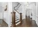 Inviting entryway features wood floors, elegant staircase, and open access to other living spaces at 543 Guilford Cir, Raleigh, NC 27608
