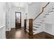 Elegant foyer with hardwood floors, a staircase, and a paneled wall at 543 Guilford Cir, Raleigh, NC 27608