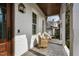 Relaxing front porch featuring comfortable seating, stylish lighting, and views of the surrounding neighborhood at 543 Guilford Cir, Raleigh, NC 27608