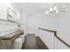 Bright hallway boasts dark wood floors, white wainscoting, and a decorative table with seating at 543 Guilford Cir, Raleigh, NC 27608