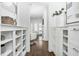 Hallway with built-in shelving, dark wood floors, and an open view to the living room at 543 Guilford Cir, Raleigh, NC 27608