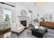 Stylish living room featuring a cozy fireplace, neutral decor, and ample natural light at 543 Guilford Cir, Raleigh, NC 27608
