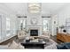 Beautiful living room with a fireplace, neutral furniture, and elegant lighting at 543 Guilford Cir, Raleigh, NC 27608